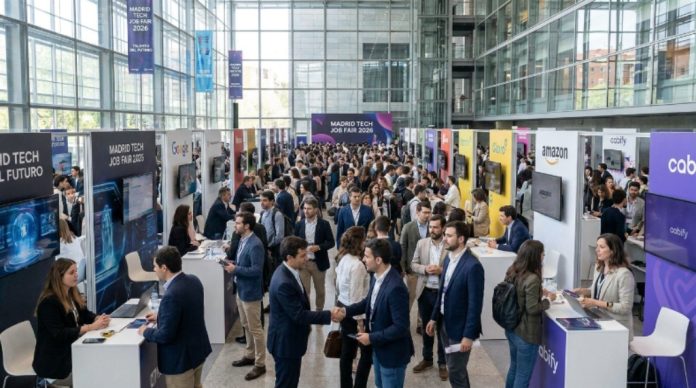 Job seekers speaking with tech company recruiters at the Madrid Tech Job Fair 2026 inside a large modern venue